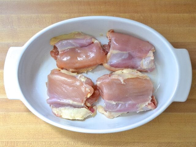 Raw Chicken Thighs in casserole dish 