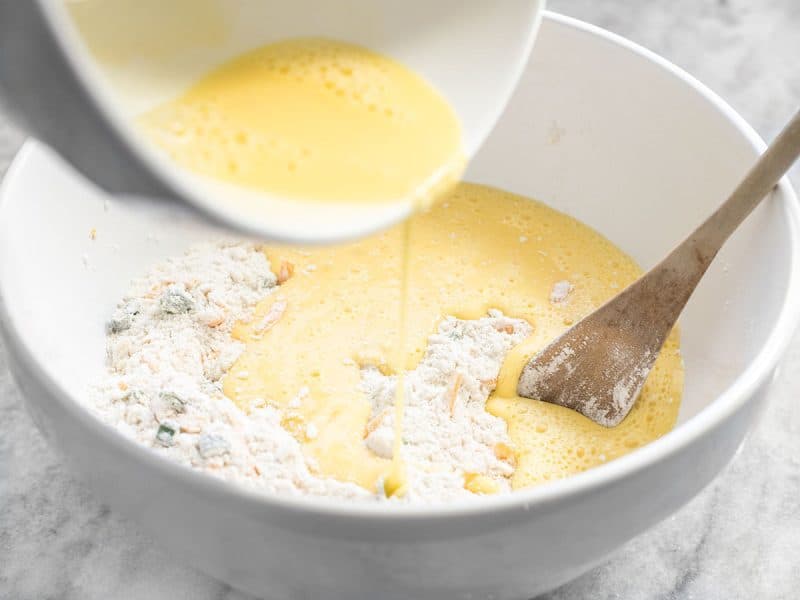 Egg mixture being poured into mixing bowl with dry ingredients 