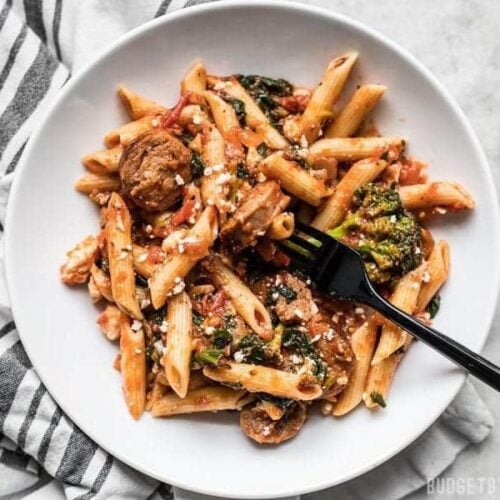 This super easy and satisfying, "sweep the kitchen" Penne Pasta with Sausage and Greens is an entire meal in one pot. Cook once, eat all week.