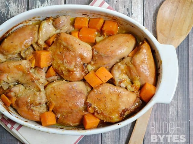 A close-up of soy Dijon chicken thighs on a serving plate.