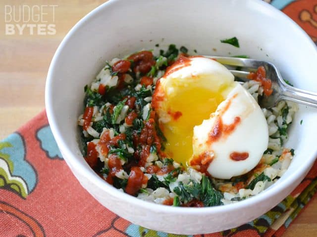 A close-up of spinach rice breakfast bowl with eggs.