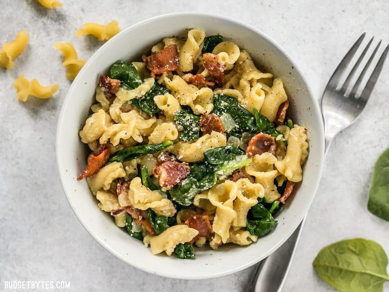 Bacon and Spinach Pasta with Parmesan is a quick and flavorful weeknight dinner that only requires a few ingredients. BudgetBytes.com