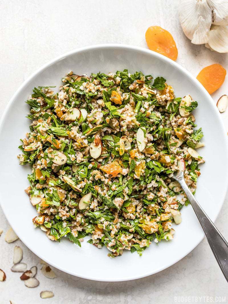 Top view of a bowl of Parsley Salad with Almonds and Apricots 