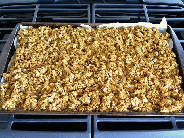 Pumpkin Granola spread on baking sheet ready to bake 