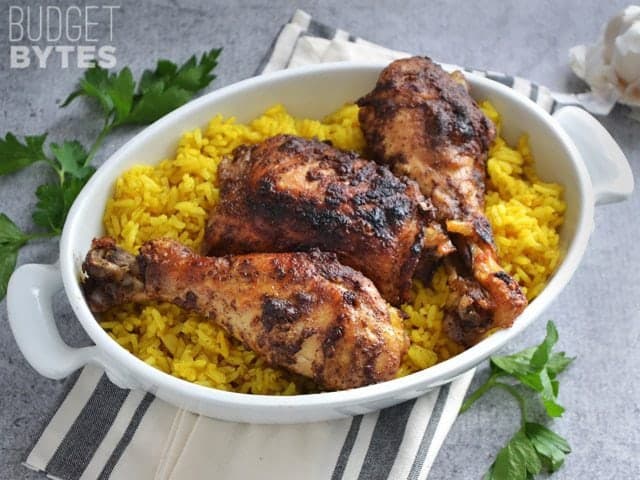 A bowl of Slow Cooker 5 Spice Chicken over a bed of rice, napkin and cilantro on the side for staging 