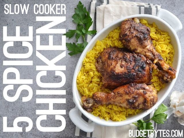 Top view of a bowl of Slow Cooker 5 Spice Chicken over a bed of rice, napkin and cilantro on the side for staging 