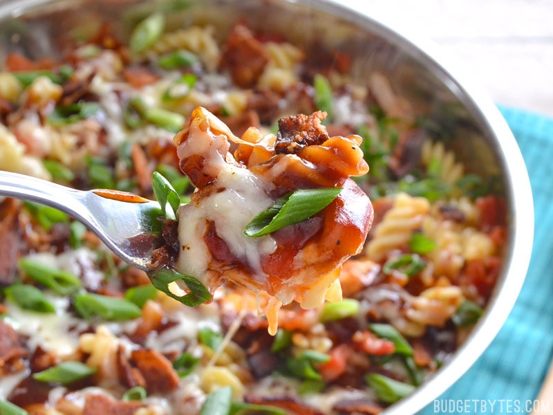 Close up of a forkful of Monterey Chicken Skillet with full skillet in background 