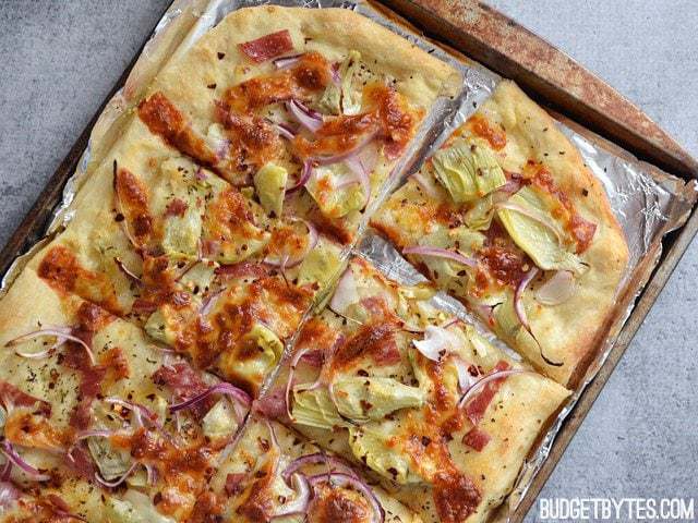 Sliced spicy Italian flatbread on a tray.