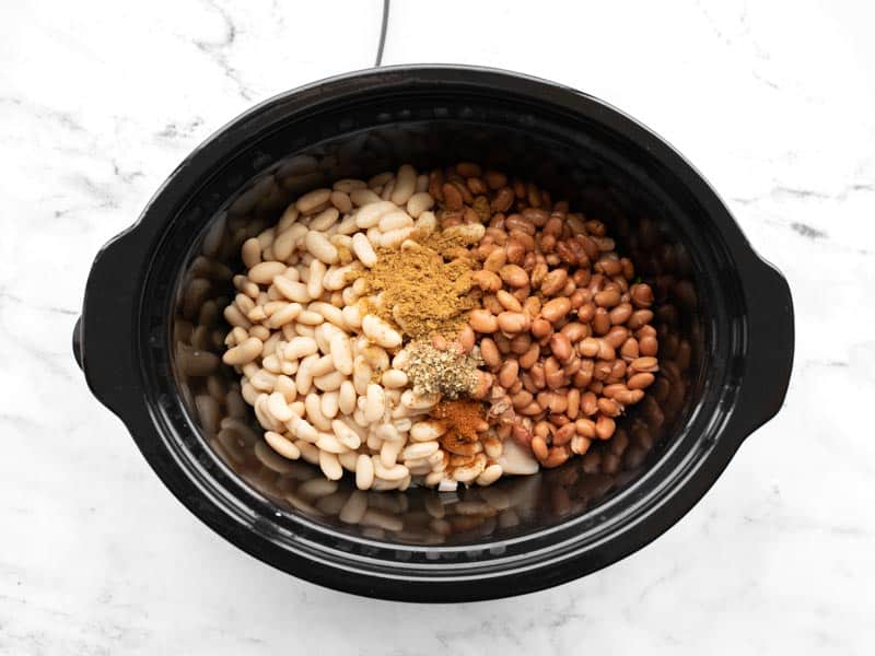 Beans and spices added to slow cooker