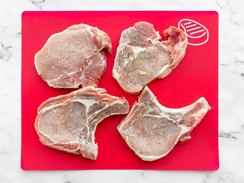 Bone-in Pork chops on a cutting board