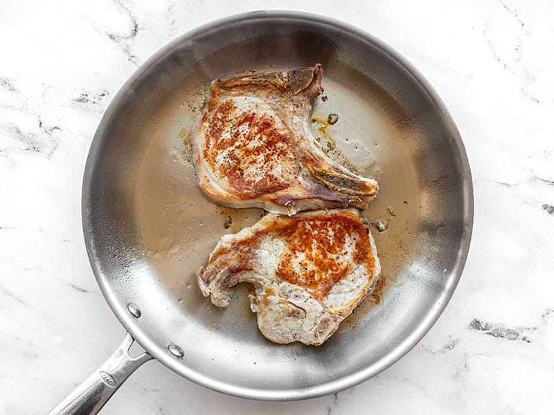 Seared pork chops in a skillet