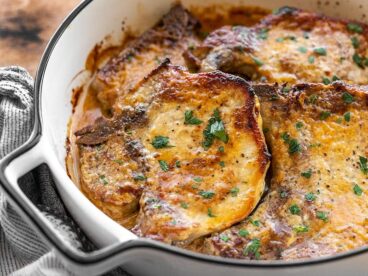 baked honey mustard pork chops in a casserole dish from the side