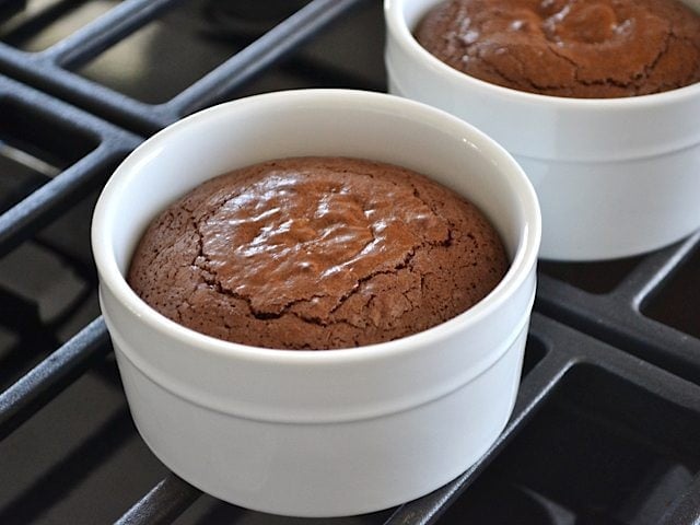 Two Baked Brownie ramekins on stove top 