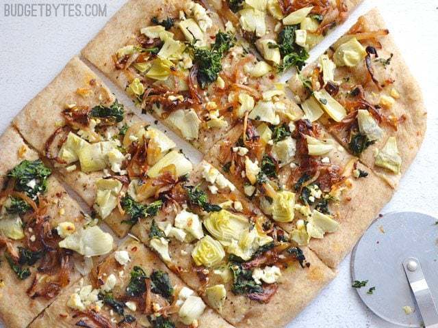 A flatbread topped with caramelized onions and artichokes.