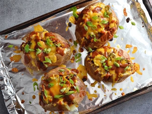 top view of four Finished Nacho Potatoes