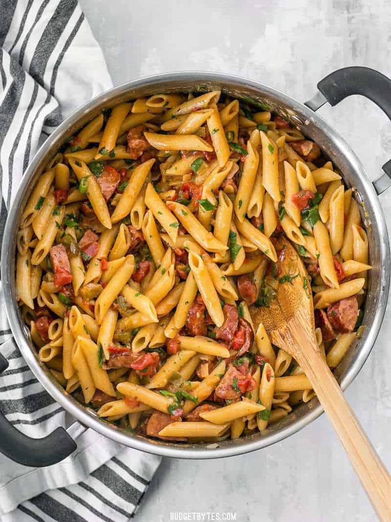 The full pot of finished Pastalaya with a wooden spoon