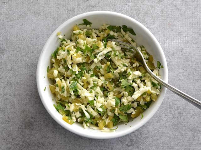 Green Chile Quesadilla Filling ingredients mixed together in bowl and stirred with fork 