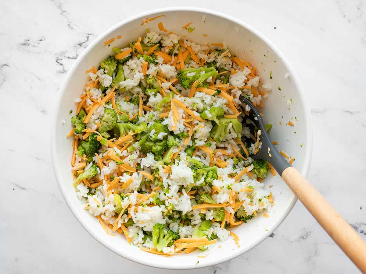 Stirred together broccoli, rice, and cheddar in the bowl