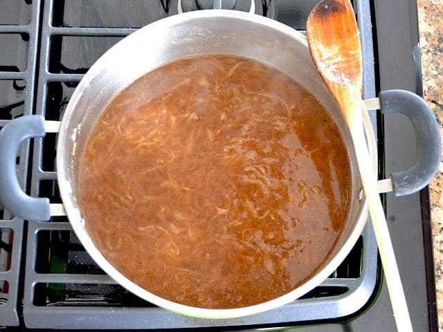 vegetable broth added to pot with seasoned onions 