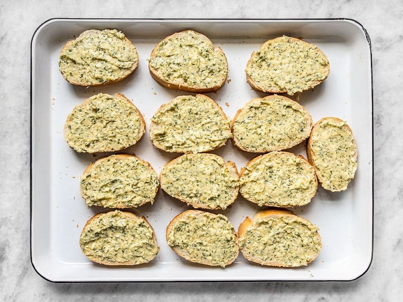 Garlic Spread on Bread Slices, on a baking sheet