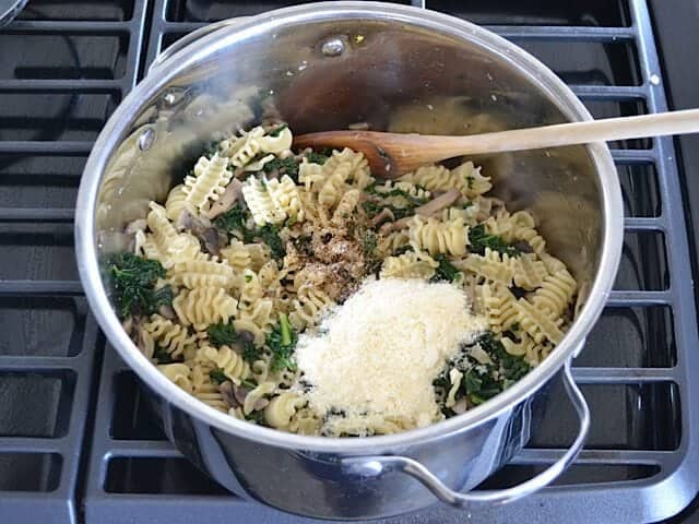 Cooked pasta, parmesan cheese  and Pepper added to pot 