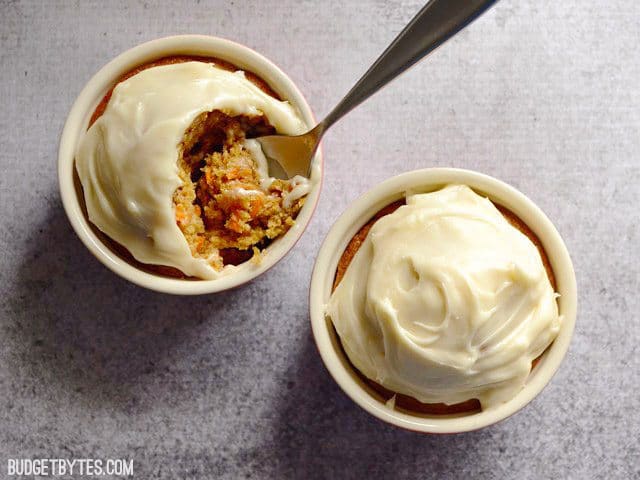 Top view of Carrot Cake for Two (two ramekins, one with spoon scooping a bite out)