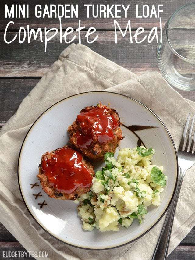 Two Garden Turkey Loafs with a side of potatoes on a plate with a fork on the side 