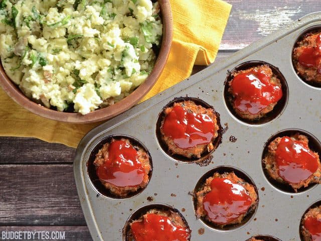 Top view of a bowl of Potatoes and muffin pan of Turkey Loaves 