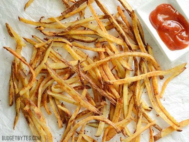 A pile of smoky garlic fries served in a rustic bowl.