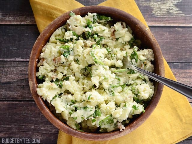 Creamy spinach and feta mashed potatoes in a bowl.