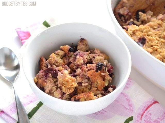 A bowl of apple cherry baked oatmeal with toppings.