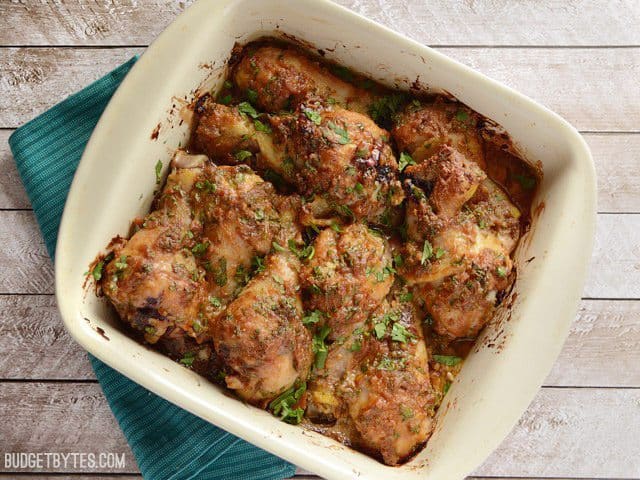 Top view of Baked Thai Peanut Chicken in a casserole dish sitting on a green napkin