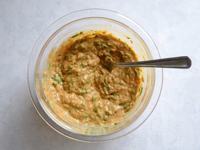 Chopped cilantro added to bowl with peanut sauce and mixed in 