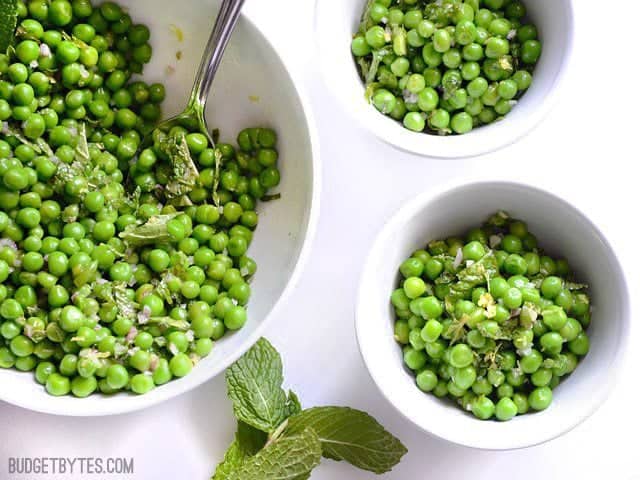 Large bowl of Minty Pea Salad with two small bowls of salad on the side 