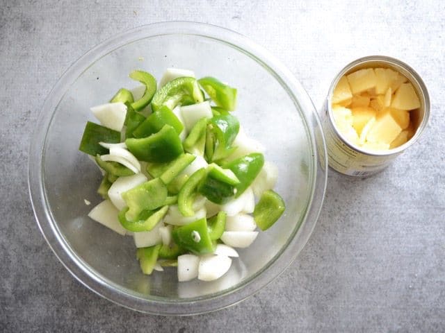 Diced Vegetables in a bowl with a can of pineapple on the side