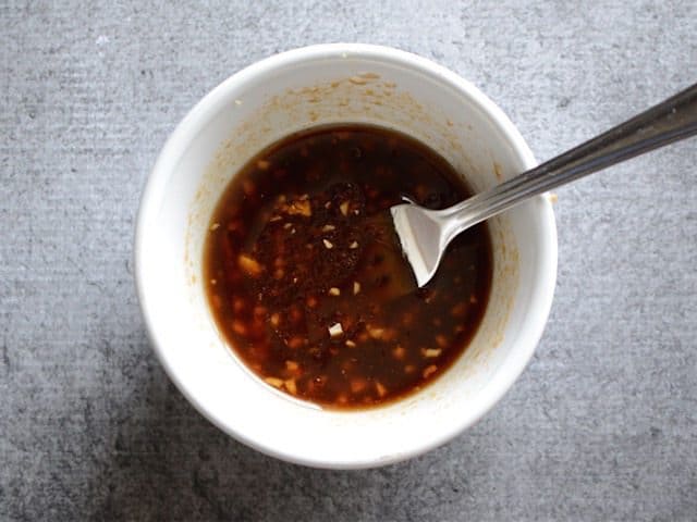 Pork Marinade in a small white bowl with a spoon