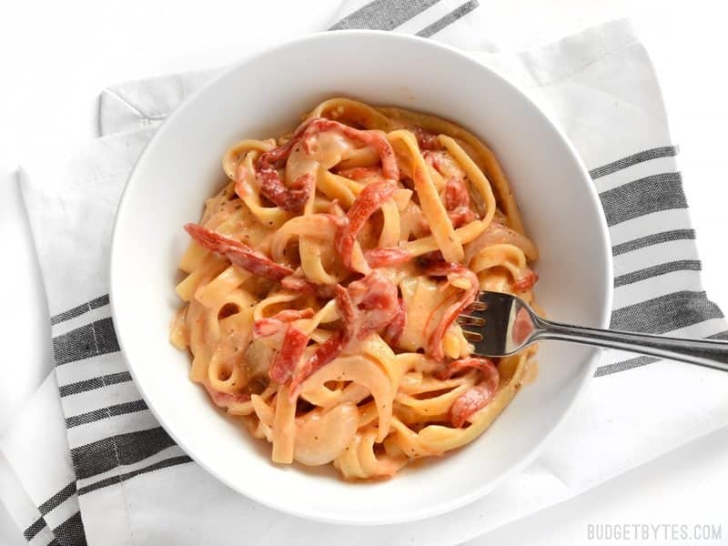 A bowl of One Pot Roasted Red Pepper Pasta with some wound around a fork