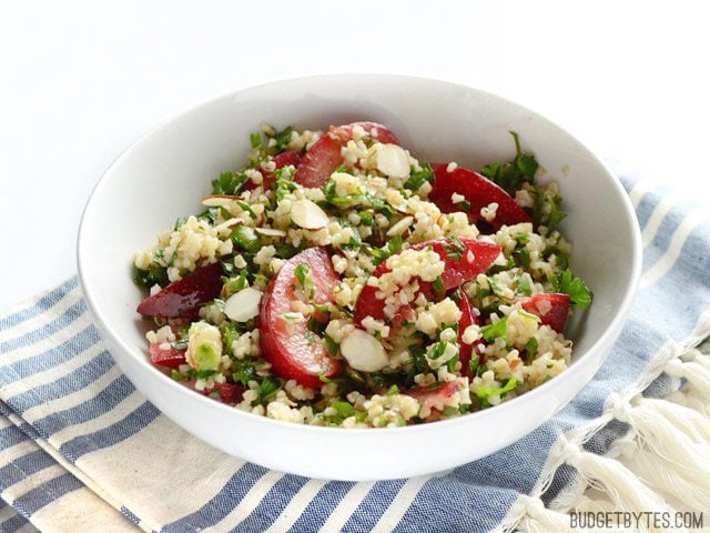 Side view of a bowl of Plum Salad with Lemon Ginger Dressing