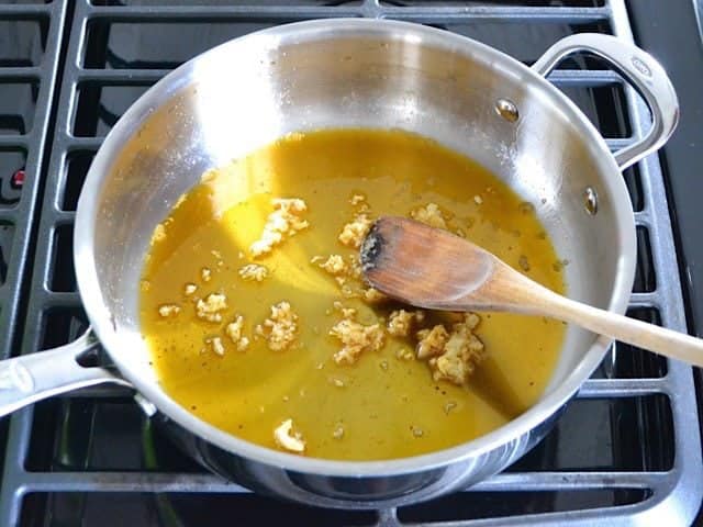 Garlic and oil in pan on stove top 