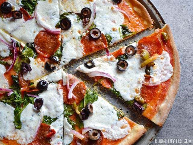 A thin, crispy pizza crust topped with fresh ingredients.