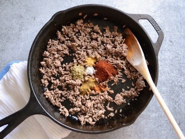 Spiced added to the browned beef in the skillet