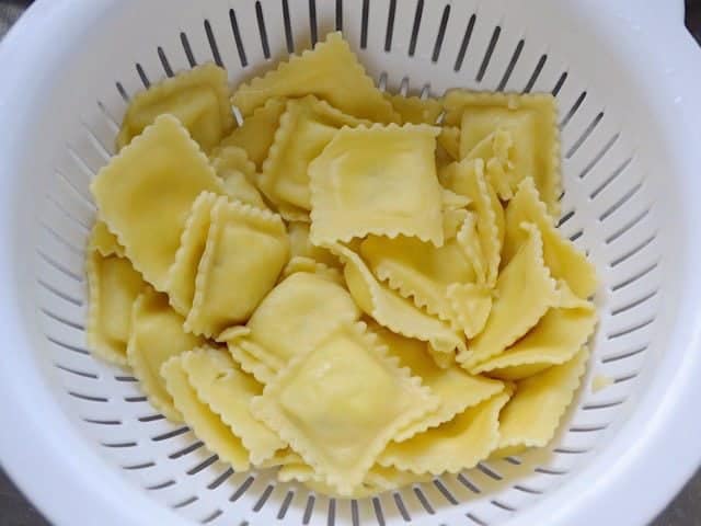 Cooked and drained Ravioli in a colander