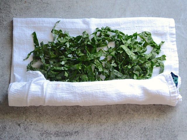 Kale being rolled up in a towel to dry