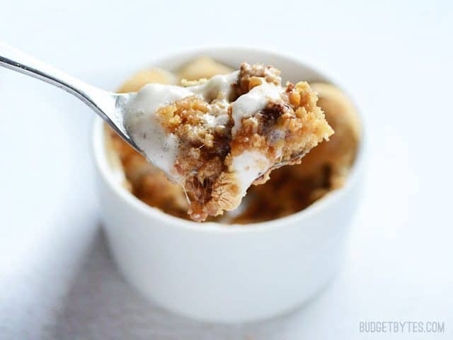 A spoon resting in a peanut butter s'mores dessert pot.