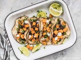 These light and refreshing Sweet Potato Tacos are filled with a simple sweet potato and black bean hash, and topped with a tangy lime crema. BudgetBytes.com