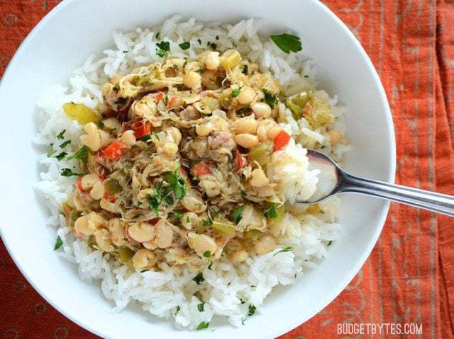 Overhead view of a bowl of Creole White Beans with Chicken served over rice