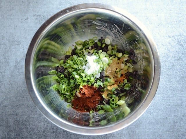 Green Onions and Spices added to mashed black beans