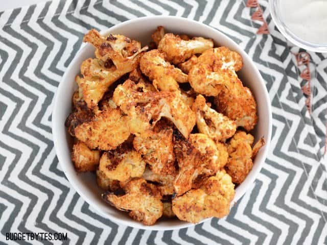 Overhead view of a bowl of Smoky Parmesan Roasted Cauliflower on a zig zag napkin