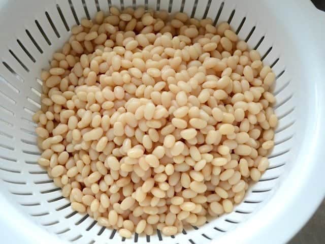 Soaked White Beans draining in a colander