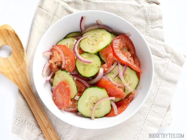 A fresh tomato cucumber salad served in a bowl.